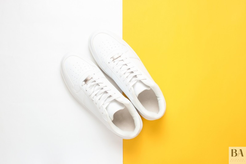 White sneakers on a white and yellow background.